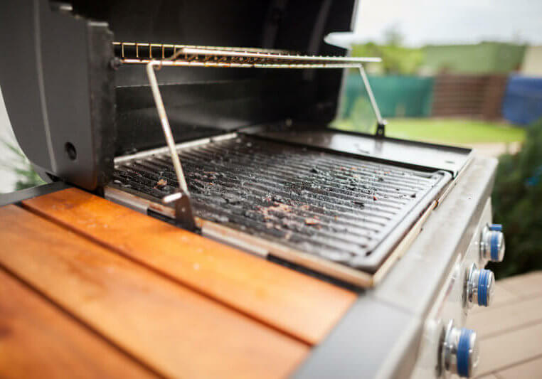 Very polluted modern grill after summer grilling (focus on grate)
